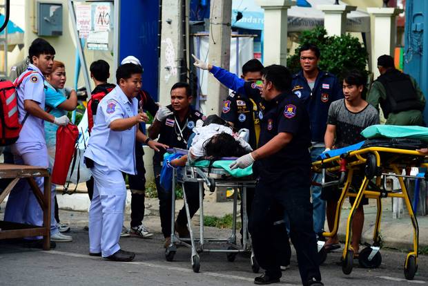 Thai rescue workers attend to an injured victim after a bomb exploded in Hua Hin