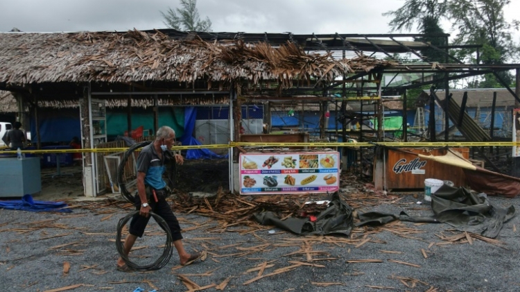 The site of a bomb blast and arson attack on Bang Niang market in Thailand's Phang Nga province is roped off with crime scene tape