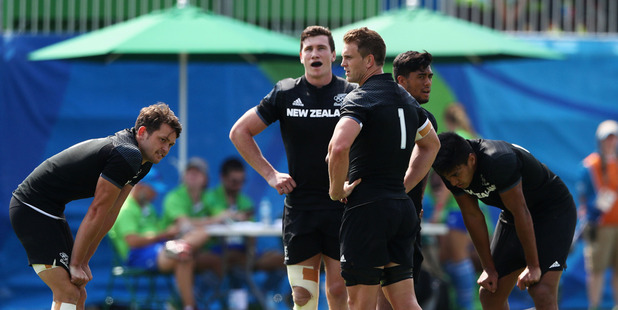 The New Zealand sevens team look dejected following a shock defeat to Japan