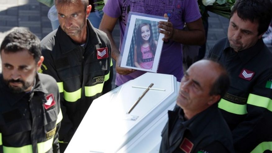 The coffin of Giulia 9 years old is carried outside the gymnasium at the end of the state funeral service in Ascoli Piceno Italy