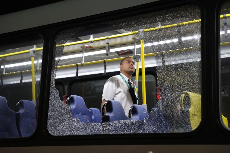 The damages to the windows of an Olympic bus