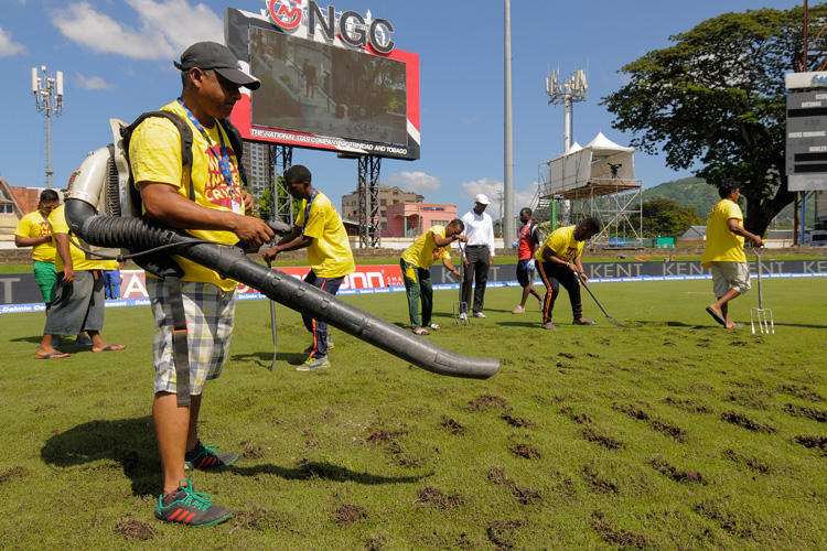 The groundsmen resorted to digging up parts of the outfield to aid the drying process