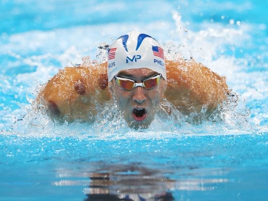 When is Michael Phelps racing? How many Olympic medals has he won? Has he been cupping?