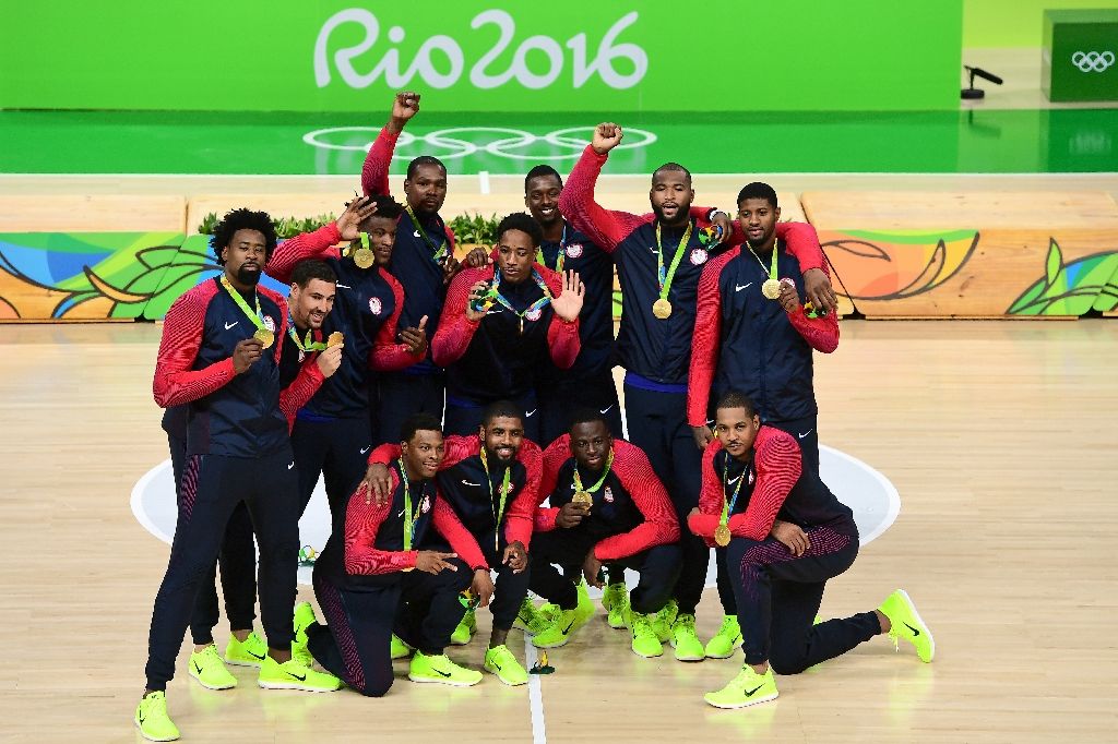 The members of the USA men's basketball team celebrate with their gold medals