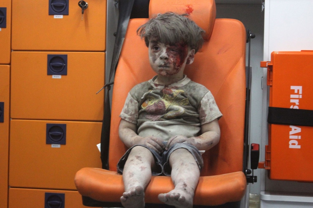 Heartbreaking footage of five-year-old boy dazed and bloodied after airstrike highlights horror of Syria's civil war