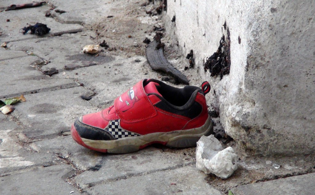 The shoe of a young victim and a piece of metal lie near the scene of Saturday's bomb attack in Gaziantep southeastern Turkey