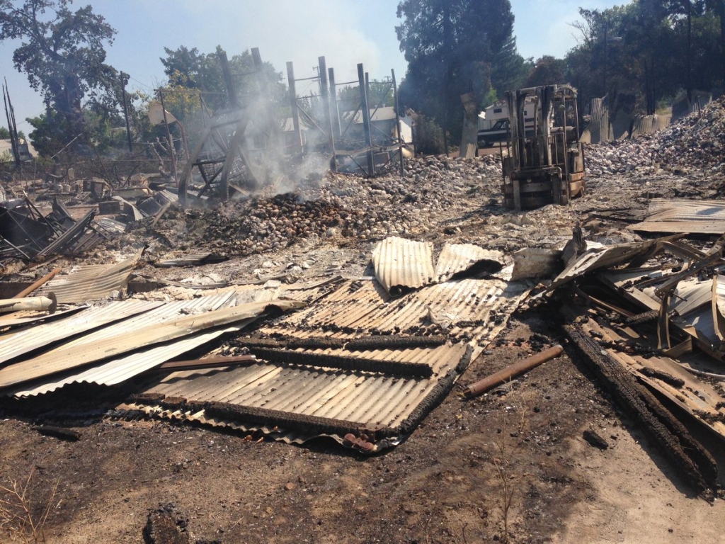 The warehouse for a candlemaking business reduced to charred rubble after the Clayton Fire swept through downtown Lower Lake