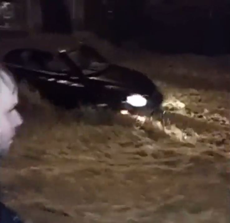 10		

	The woman’s car is seen stranded in the torrential flood water