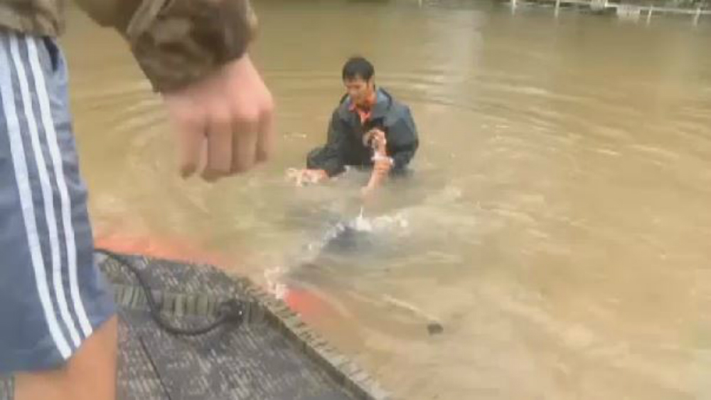 Footage shows man rescuing woman and her dog from sinking car