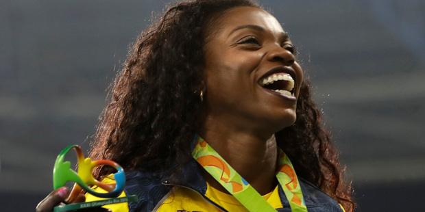 Colombia's Caterine Ibarguen celebrates with the gold medal during the medal ceremony for the women's triple jump final at the athletics competitions