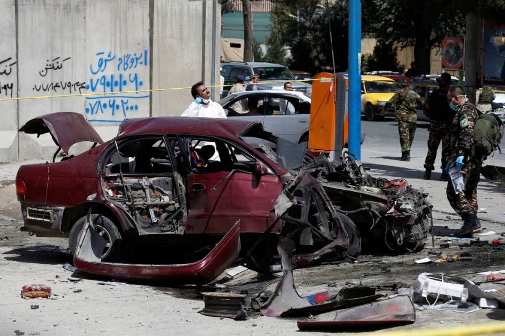 Afghan personnel investigate at the site of a bomb blast near the U.S. Embassy in Kabul Afghanistan