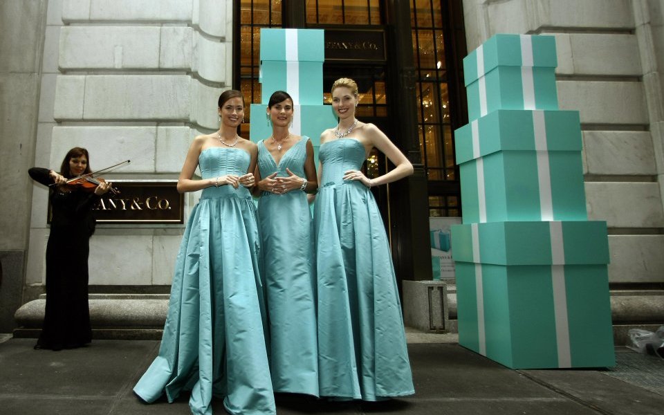 Models stand outside the entrance to the