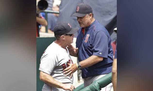 Boston Red Sox manager John Farrell right holds back third base coach Brian Butterfield in the dugout after Butterfield was ejected during the second inning of a baseball game against the Detroit Tigers Thursday Aug. 18 2016 in Detroit. (AP