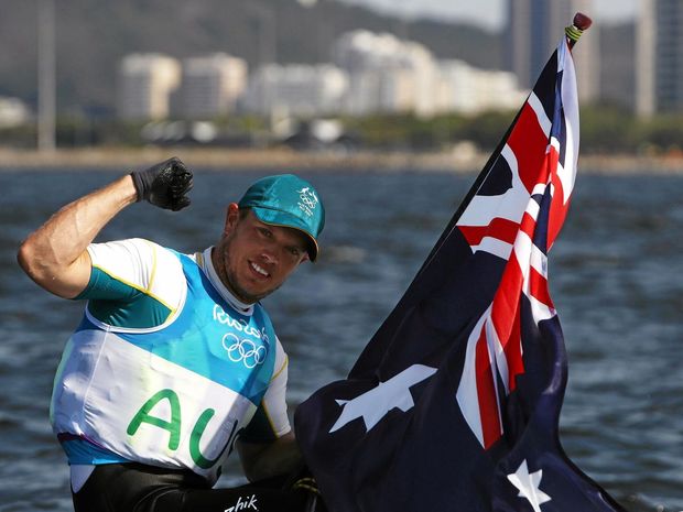 Tom Burton of Australia celebrates winning the gold medal in the Men's Laser class