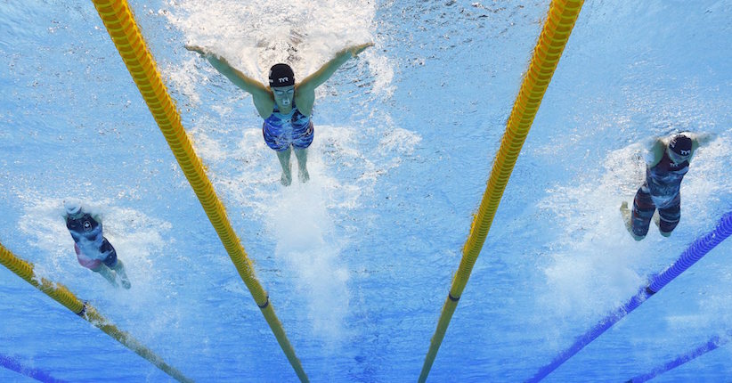 United States Dana Vollmer centre leads Denmark's Jeanette Ottesen right and Canada's Penny Oleksiak left in the the third leg of the women's 4x100 meter medley relay final during the swimming competitions at the 2016 Summer Olympics Saturday Aug