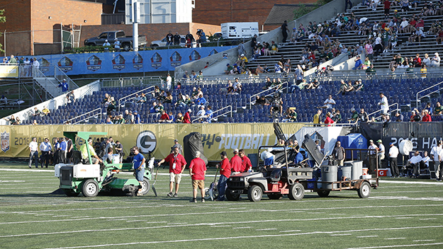 Crews work on the field prior to the 2016 NFL Hall of Fame Game at Tom Benson Hall of Fame Stadium in Canton Ohio. The game was eventually canceled due to poor field conditions