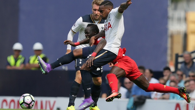 Tottenham's Danny Rose front competes for the ball with Liverpool's Sadio Mane as Tottenham's Christian Eriksen looks on during the English Premier League soccer match between Tottenham Hotspur and Liverpool at White Hart Lane in London Saturday Aug