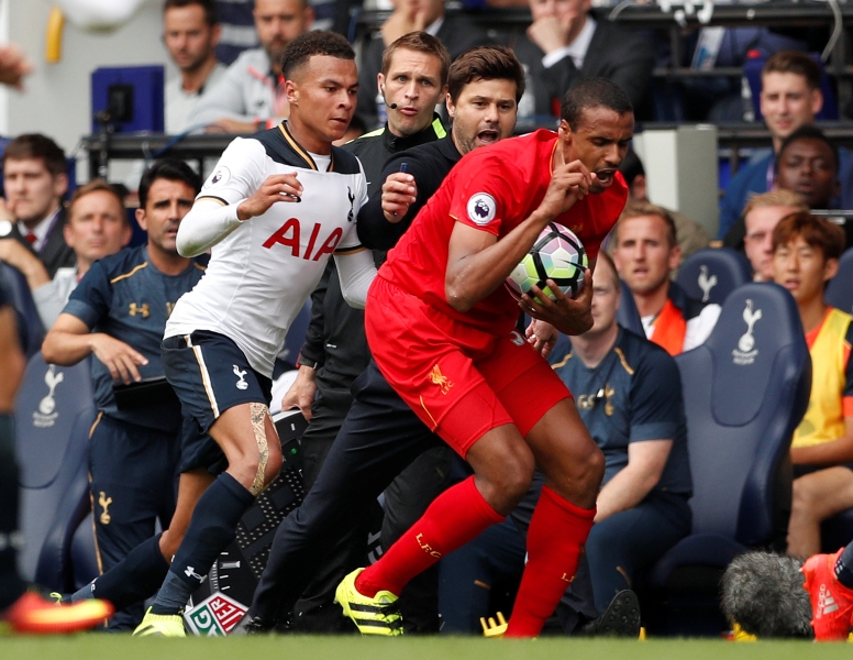 Tottenham's Dele Alli and manager Mauricio Pochettino attempt to retrieve the ball off Liverpool's Joel Matip. Reuters  John Sibley