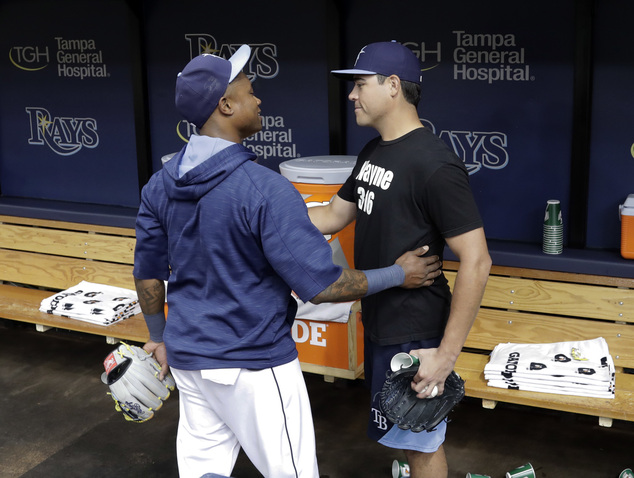 Tampa Bay Rays shortstop Tim Beckham left hugs starting pitcher Matt Moore after Moore was traded to the San Francisco Giants before a baseball game Monday