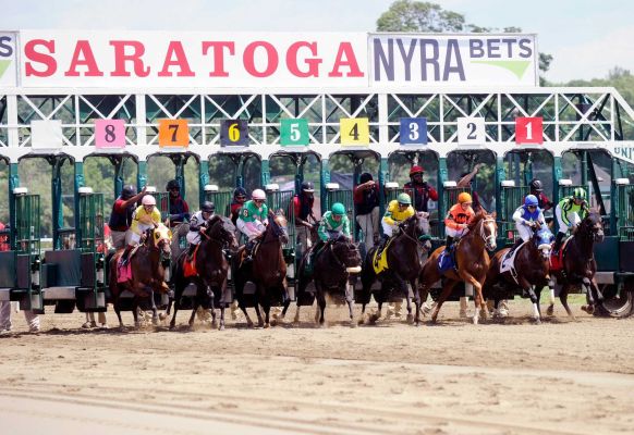 The horses break from the starting gate during