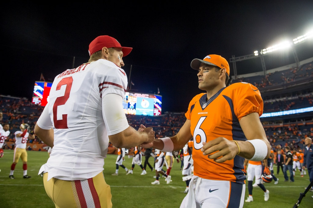 DENVER CO- AUGUST 20 Quarterback Blaine Gabbert of the San Francisco 49ers and quarterback Mark Sanchez of the Denver Broncos shake hands after a preseason NFL game at Sports Authority Field at Mile High