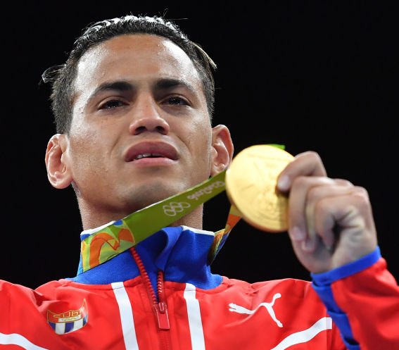 Cuba's Robeisy Ramirez reacts as he poses on the podium with a bronze medal at the Rio 2016 Olympic Games at the Riocentro- Pavilion 6 in Rio de Janeiro