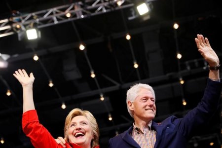 Democratic presidential candidate Hillary Clinton waves to the crowd with her husband former president Bill Clinton at the David L. Lawrence Convention Center in Pittsburgh Pennsylvania