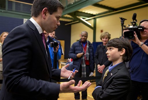 Peter Reid 11 of Epsom N.H. asks Republican presidential candidate Sen. Marco Rubio R-Fla. a question about the Islamic State group and his foreign policy ideas after attending the final rally before the New Hampshire primary at Nashua Community Col