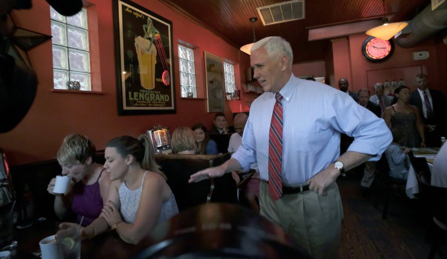 Republican vice presidential candidate Indiana Gov. Mike Pence right surprises patrons at Millie's Diner in Richmond Va. Saturday Aug. 27 2016 during an impromptu visit by the candidate to the popular restaurant. (Bob Brown  Richmond Times-Disp