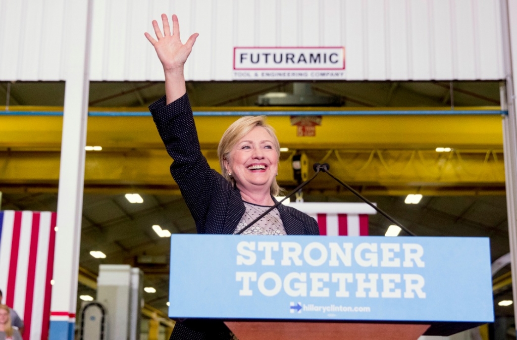 Democratic presidential candidate Hillary Clinton waves as she finishes a speech on the economy after touring Futuramic Tool & Engineering in Warren Mich. Thursday Aug. 11 2016