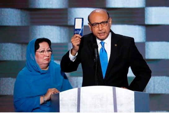 Khizr Khan father of fallen US Army Capt. Humayun S. M. Khan holds up a copy of the Constitution of the United States as his wife listens during the final day of the Democratic National Convention in Philadelphia