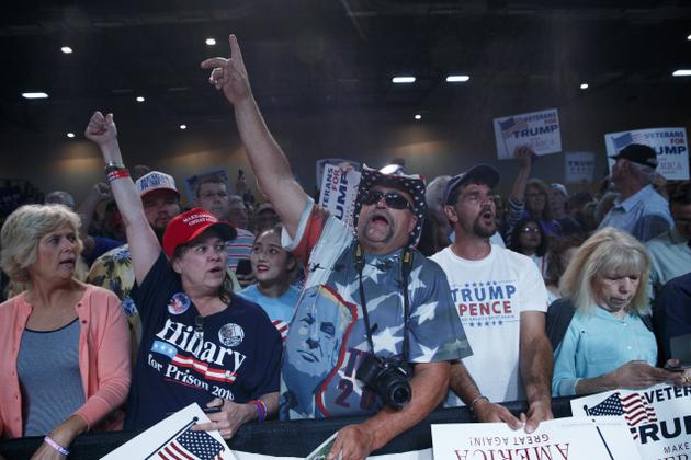 Supporters o Donald Trump cheer during a campaign rally in Des Moines Iowa on Friday  supporters of Hillary Clinton in Grand Rapids Michigen. Paul Ryan and John McCain