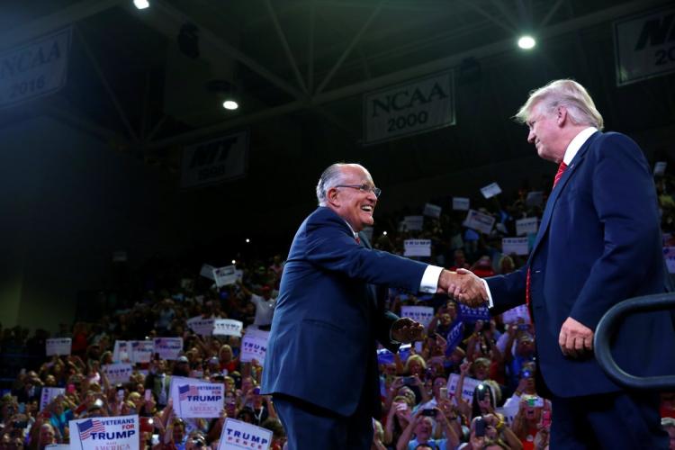 Former New York City Mayor Rudy Giuliani greets Republican U.S. presidential nominee Donald Trump at the Trask Coliseum at University of North Carolina Tuesday