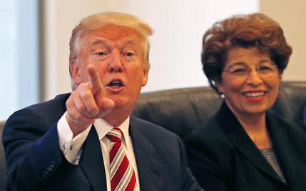 Republican presidential candidate Donald Trump holds a Hispanic advisory roundtable meeting in New York Saturday Aug. 20 2016. At right is Jovita Carranza former Small Business Administration Deputy Administrator