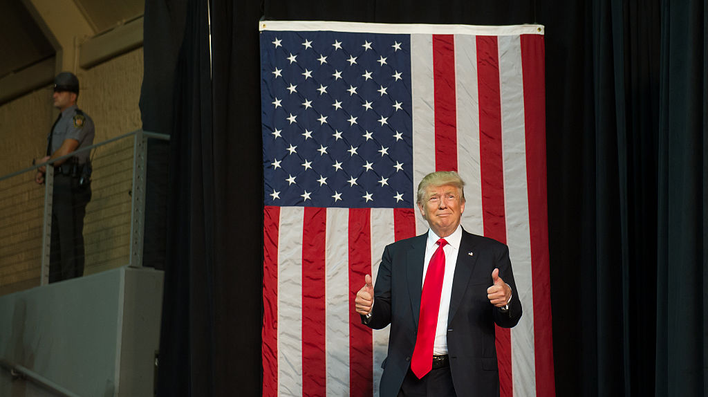 Republican presidential candidate Donald Trump gestures as he arrives to speak to supporters at a rally at Erie Insurance Arena