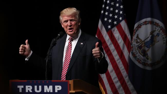 Republican presidential nominee Donald Trump holds two thumbs up during a campaign event at Briar Woods High School