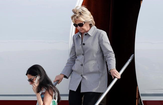 Democratic presidential nominee Hillary Clinton and aide Huma Abedin lower left step from Clinton's campaign plane as they arrive at Van Nuys Airport in Van Nuys Calif. Monday Aug. 22 2016 en route to a taping of'Jimmy Kimmel Live! in Los An