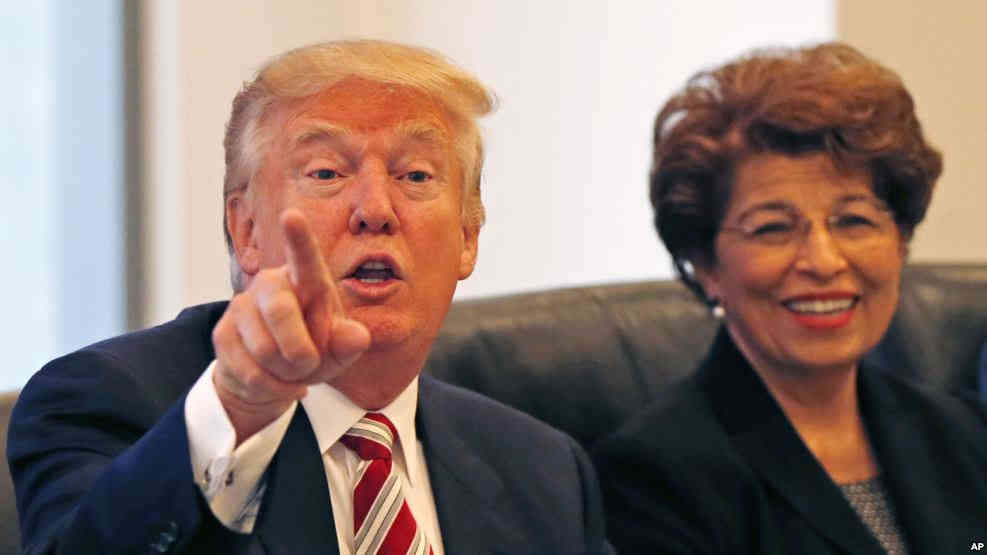 Republican presidential candidate Donald Trump holds a Hispanic advisory roundtable meeting in New York Aug. 20 2016. At right is Jovita Carranza former Small Business Administration Deputy Administrator