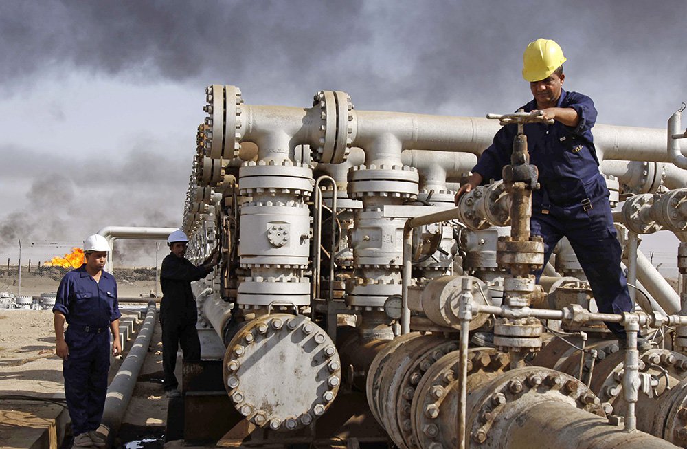 Iraqi workers maintain valves at the Rumaila oil refinery near Basra about 340 miles southeast of Baghdad. Donald Trump has said he would have used money from the sale of Iraqi oil to pay for the care of wounded soldiers and the families of those Americ