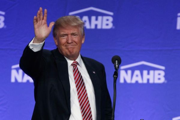 Republican presidential candidate Donald Trump waves after speaking