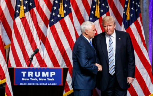 AFP  Kena Betancur. US Republican presidential candidate Donald Trump shakes hands with vice presidential candidate Mike Pence