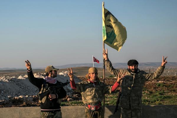 Syrian Kurdish militia members of the YPG make a V-sign in Esme village in Aleppo province Syria