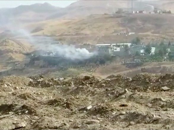 Smoke rises from buildings at the site of a car bomb explosion at a police headquarters in Cizre located in Turkey's Sirnak province bordering both Syria and Iraq in this still image from video