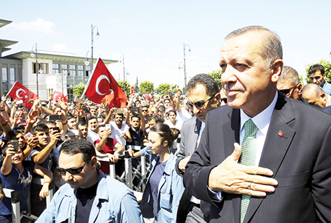 Turkey's President Recep Tayyip Erdogan acknowledges the crowd as he arrives at the parliament in Ankara Turkey. Turkish lawmakers approved a three-month state of emergency that allows the government to extend detent