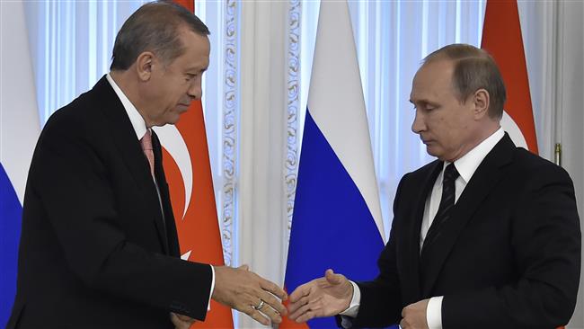 Russian President Vladimir Putin shakes hands with his Turkish counterpart Recep Tayyip Erdogan during their press conference in Konstantinovsky Palace outside Saint Petersburg