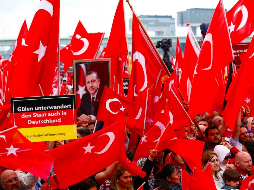 Supporters of Turkish President Tayyip Erdogan wave Turkish flags during a pro-government protest in Cologne Germany