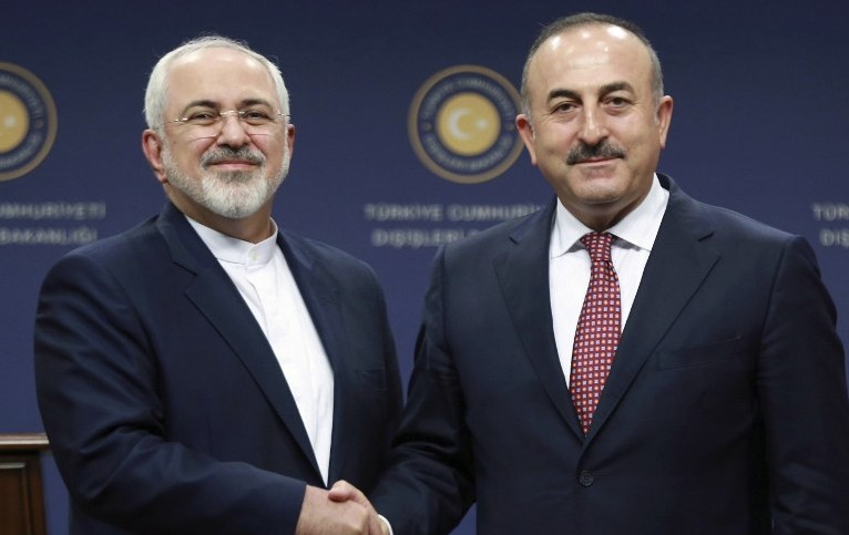 Turkish Foreign Minister Mevlut Cavusoglu right and Iran's Foreign Minister Mohammad Javad Zarif shake hands following a joint press conference at the Foreign Ministry in Ankara