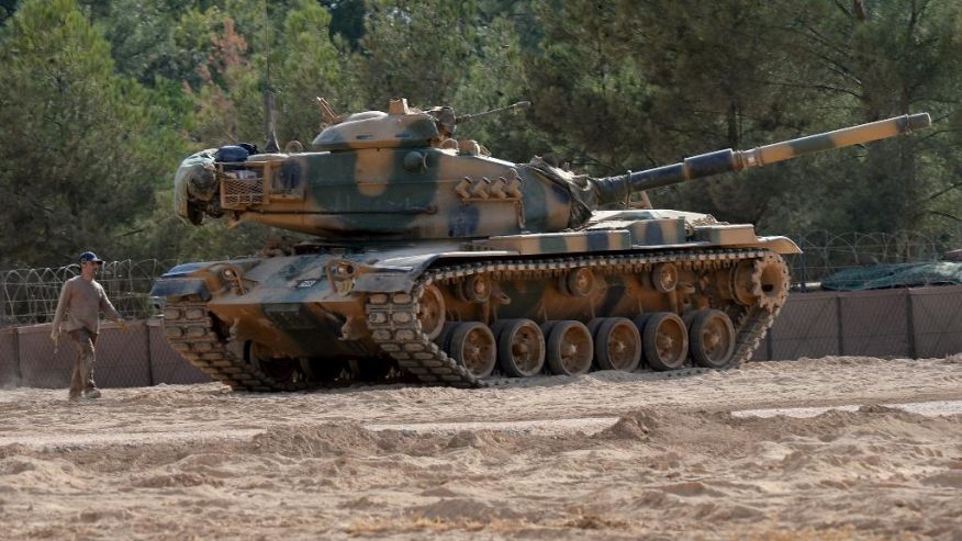 A Turkish tank stationed near the Syrian border in Karkamis Turkey Monday Aug. 29 2016. Turkey's state-run news agency says three rockets fired from Syria have hit Turkish border town of Kilis injuring five children Turkish President Recep Tay