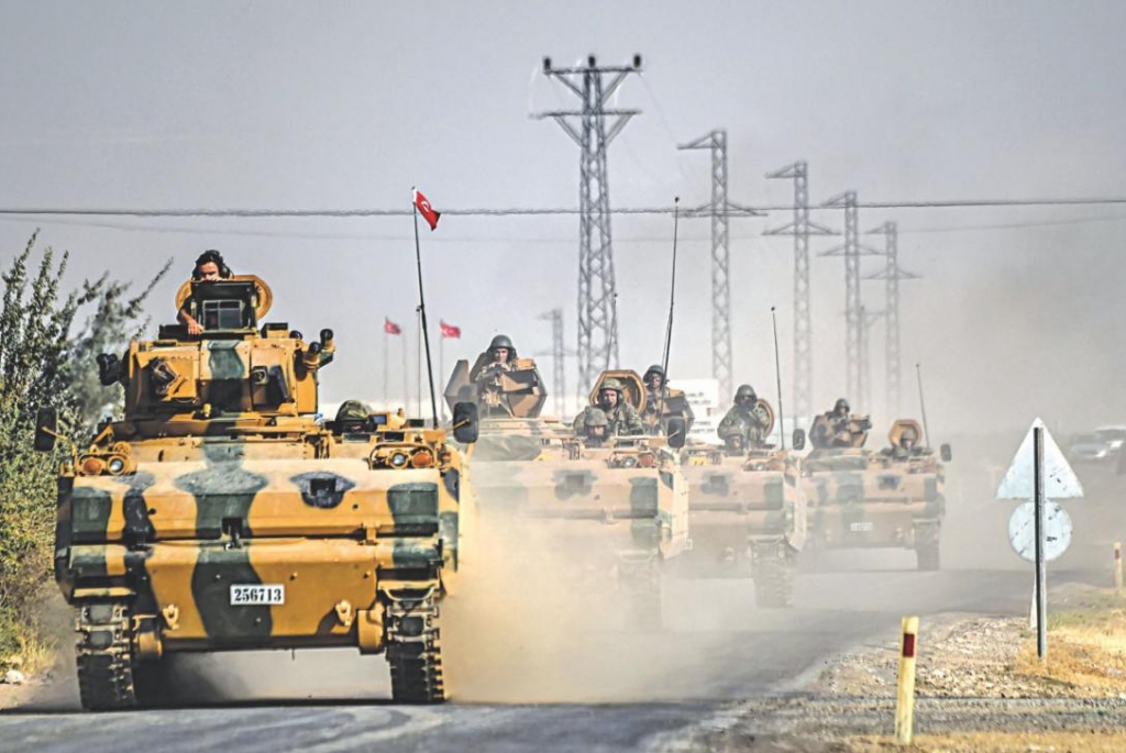 Turkish Army tanks driving to the Syrian Turkish border town of Jarabulus yesterday