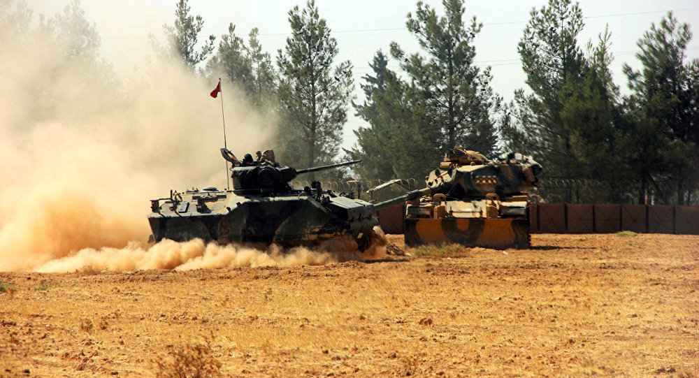 A Turkish army tank and an armoured vehicle are stationed near the Turkish Syrian border in Karkamis in the southeastern Gaziantep province Turkey